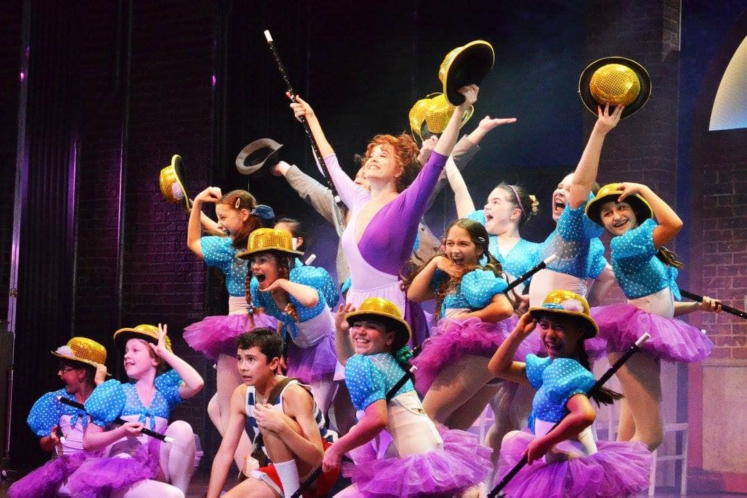 Broadway’s Leslie Becker, center, stars as ballet teacher Mrs. Wilkinson and is surrounded by her ballet students and Billy (portrayed by Nicholas Dantes, front). Photo by Jen Vasbinder.